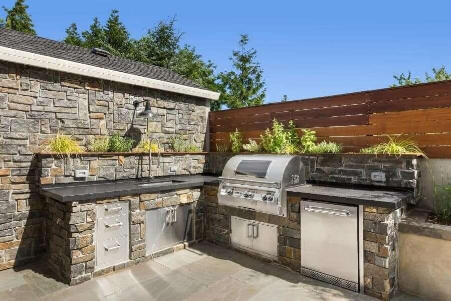 Stone outdoor kitchen with backsplash