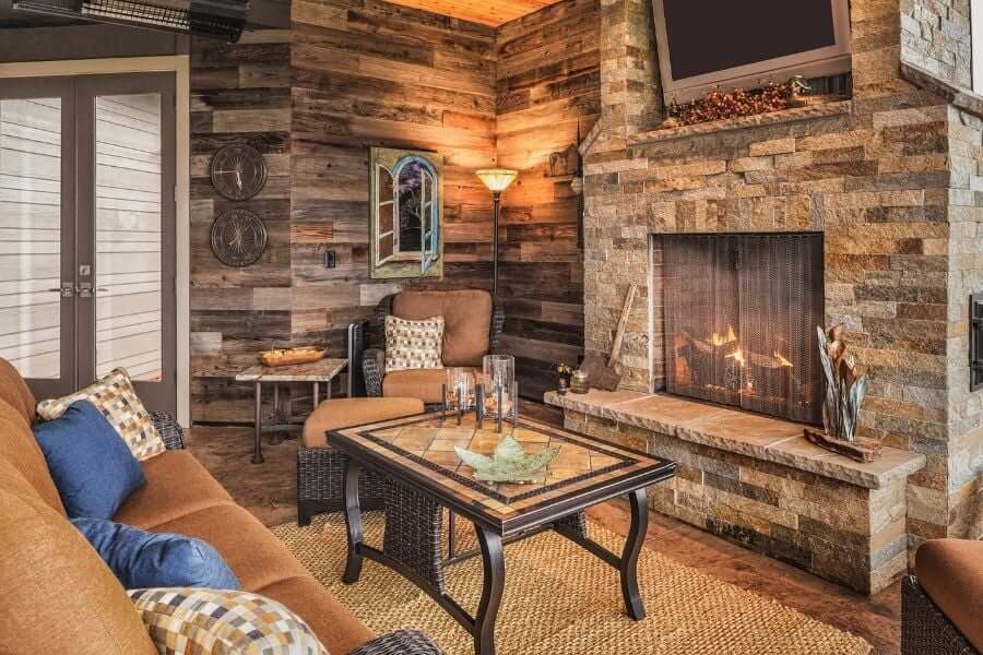 outdoor patio with an outdoor fireplace and tv